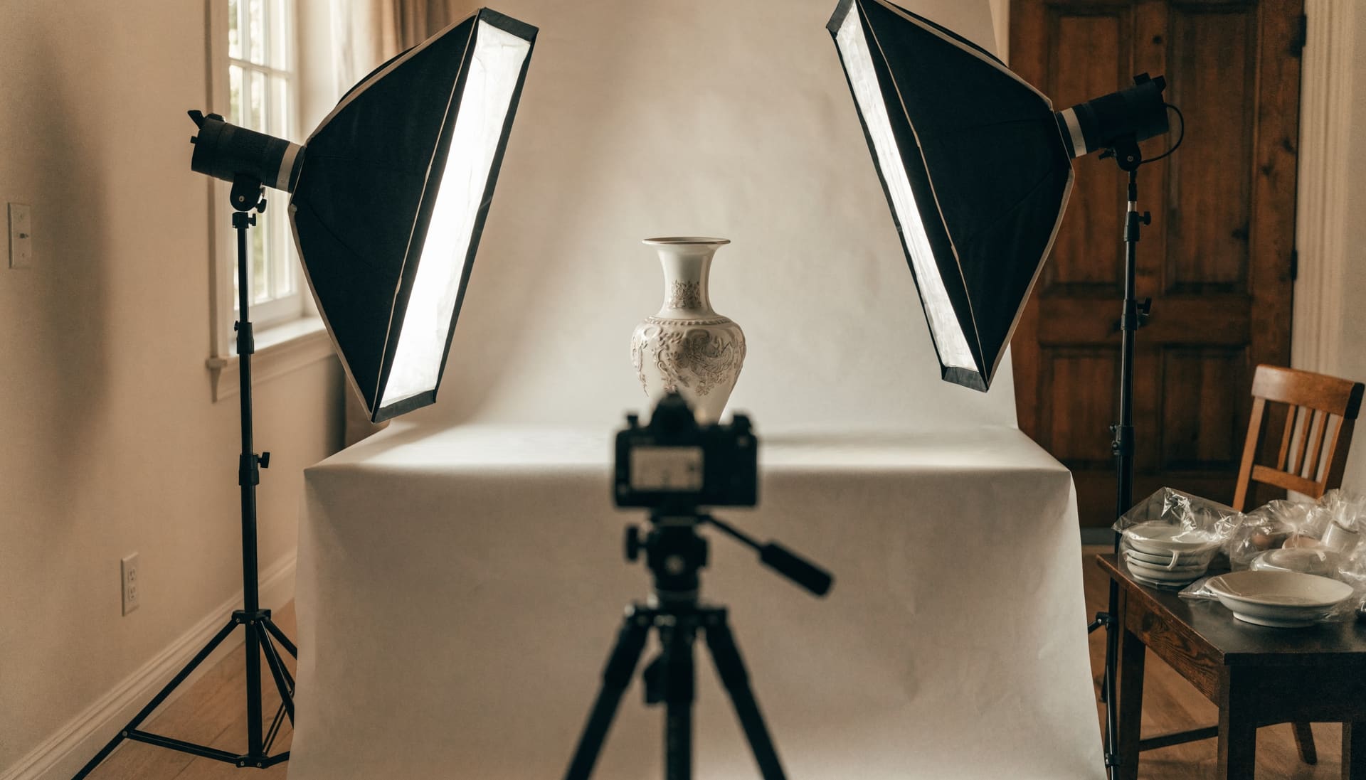 Representative image: a vase on a white backdrop between two softbox lights, ready to be photographed for a catalogue